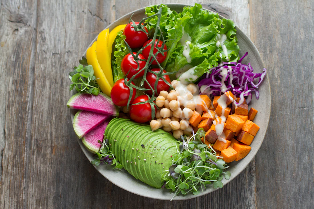 A colorful bowl of fresh vegetables, avocado and chickpeas